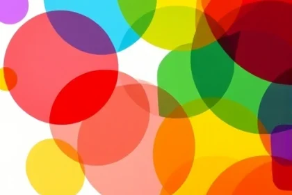 A vibrant, abstract representation of color theory with overlapping translucent circles in primary and secondary colors (red, blue, yellow, green, orange, purple) forming a dynamic, harmonious pattern on a soft white background, subtle light flares and gentle gradients enhancing depth, no text, no logos, no people, no objects, purely geometric and chromatic
