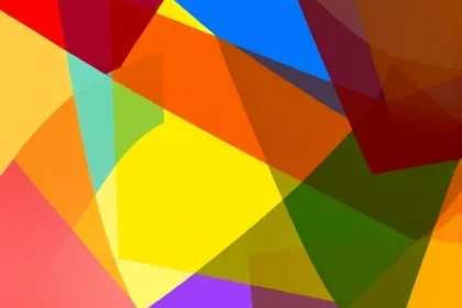 A vibrant, abstract representation of color theory in design, featuring overlapping translucent geometric shapes in bold primary and secondary colors (red, blue, yellow, green, orange, purple) forming a dynamic, harmonious composition. Subtle light flares and soft gradients enhance depth, suggesting creativity and innovation. No text, logos, or readable symbols. The mood is energetic, modern, and inspiring — evoking the idea of color as a design superpower.