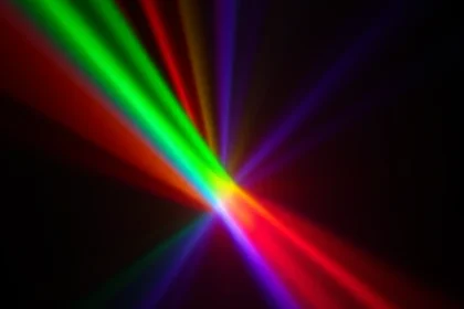 A vibrant, abstract representation of color theory in television technology, featuring overlapping RGB light beams forming a radiant spectrum against a deep black background, with subtle glowing pixels and soft lens flares suggesting CRT and OLED displays, evoking the elegance and precision of TVIColor's color reproduction