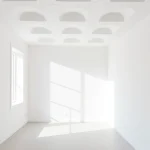 A modern apartment interior showing walls and ceiling insulated with white polystyrene foam boards, clean lines, minimalist design, soft natural lighting, no visible text or numbers
