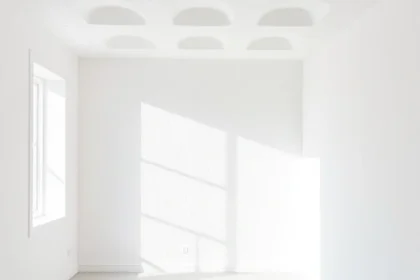 A modern apartment interior showing walls and ceiling insulated with white polystyrene foam boards, clean lines, minimalist design, soft natural lighting, no visible text or numbers