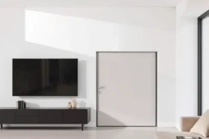 A sleek, modern living room with a hidden door seamlessly integrated into a wall, revealing a small, cozy storage space behind it. The scene showcases the door's smooth sliding mechanism, minimalist design, and the contrast between the open living area and the concealed compartment. Emphasize natural lighting, clean lines, and the sense of hidden functionality.